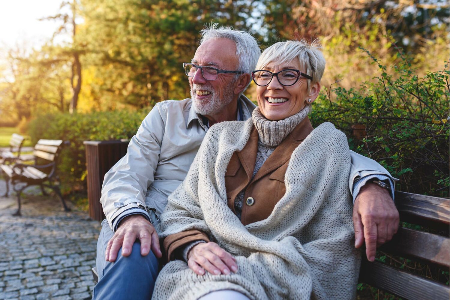 mature couple sit on a bench